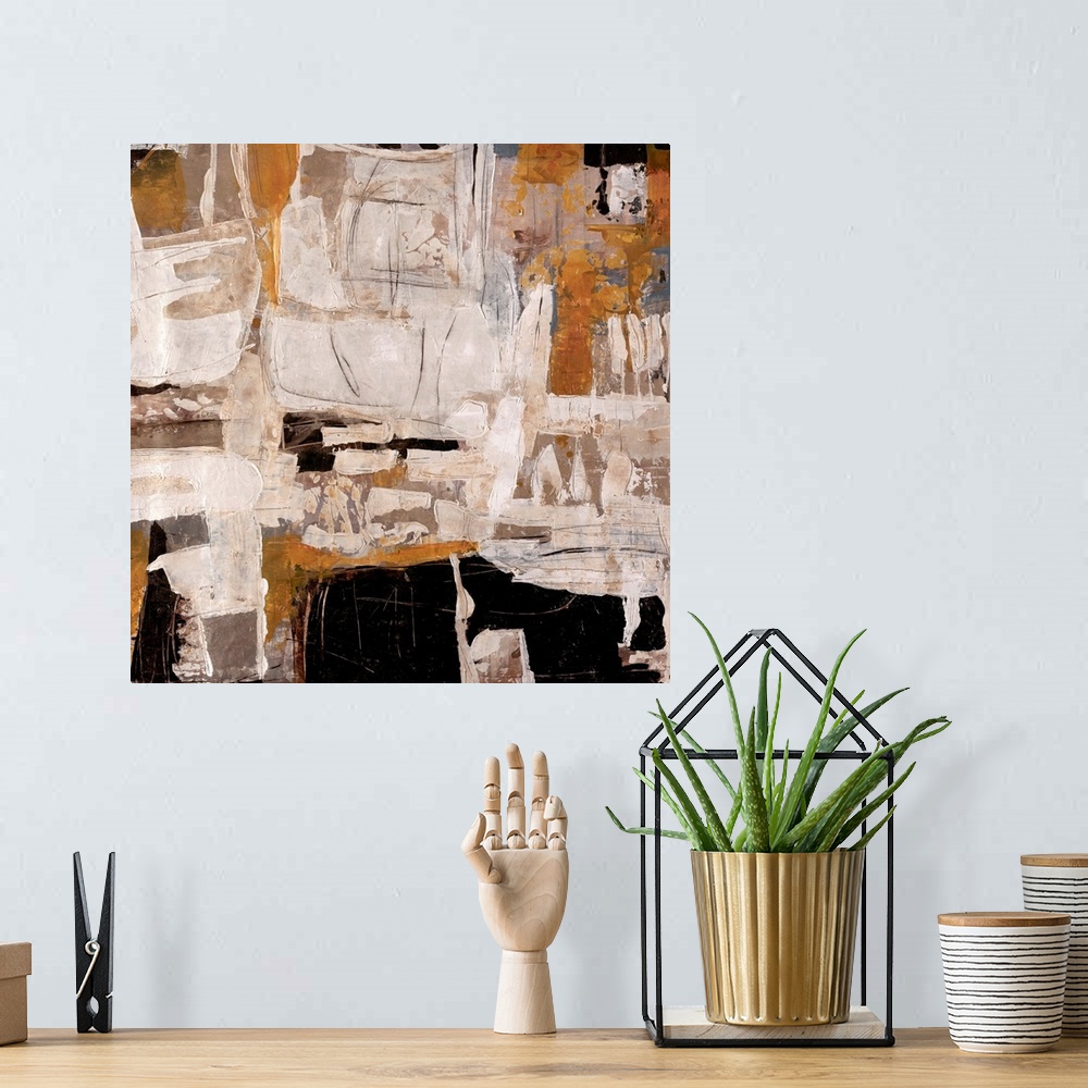 A bohemian room featuring Abstract artwork that is mostly off white with chunks of black and tan thrown in.