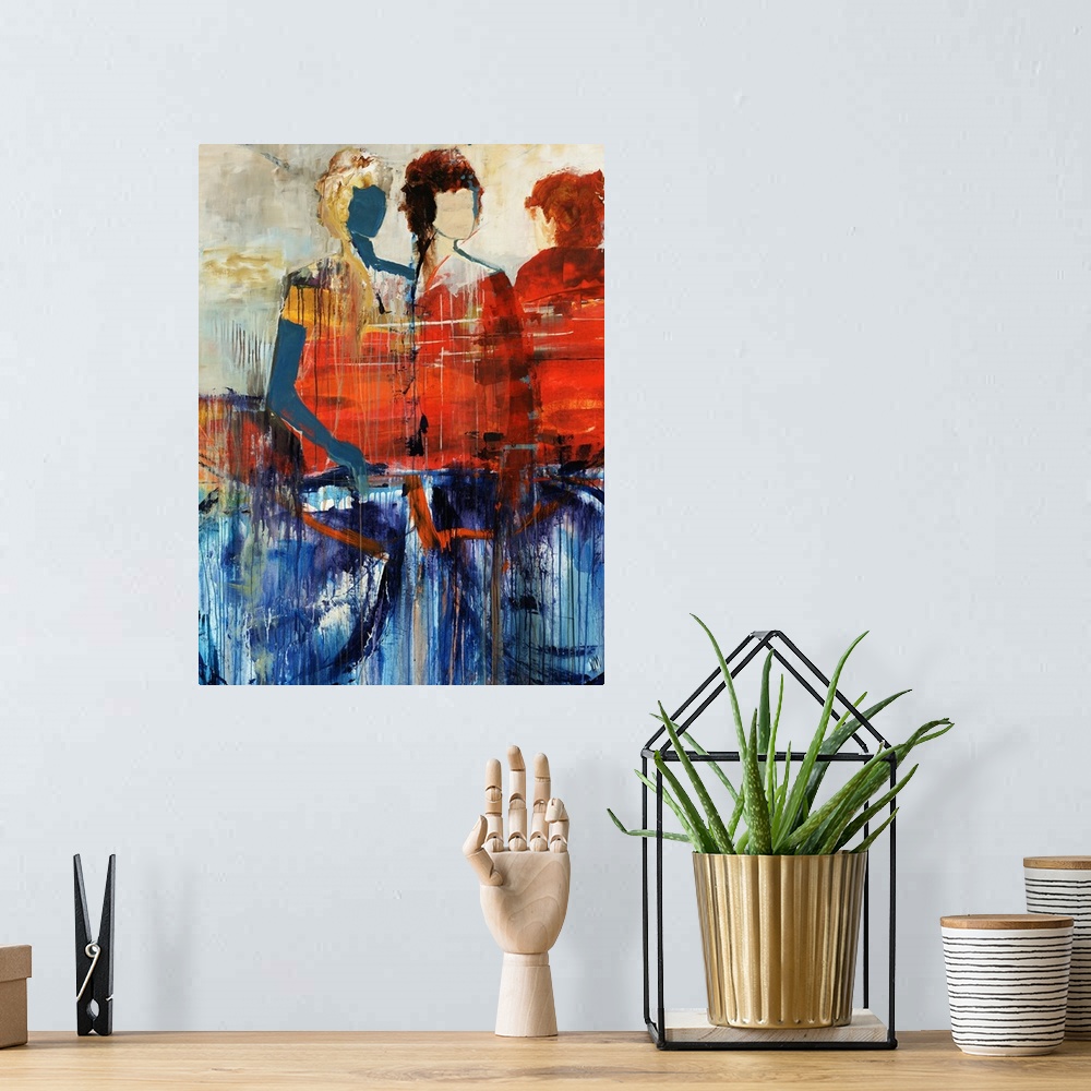 A bohemian room featuring Portrait, figurative art on a large wall hanging of three human figures standing behind a large o...