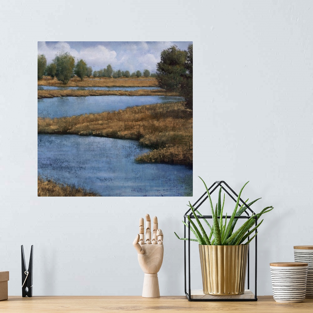 A bohemian room featuring Contemporary painting of an idyllic countryside landscape, with a winding river.