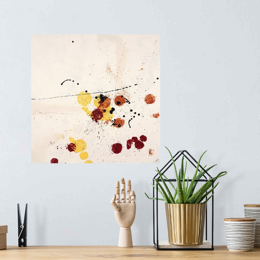 A bohemian room featuring Abstract painting using red and yellow paint splatters on a neutral toned background.