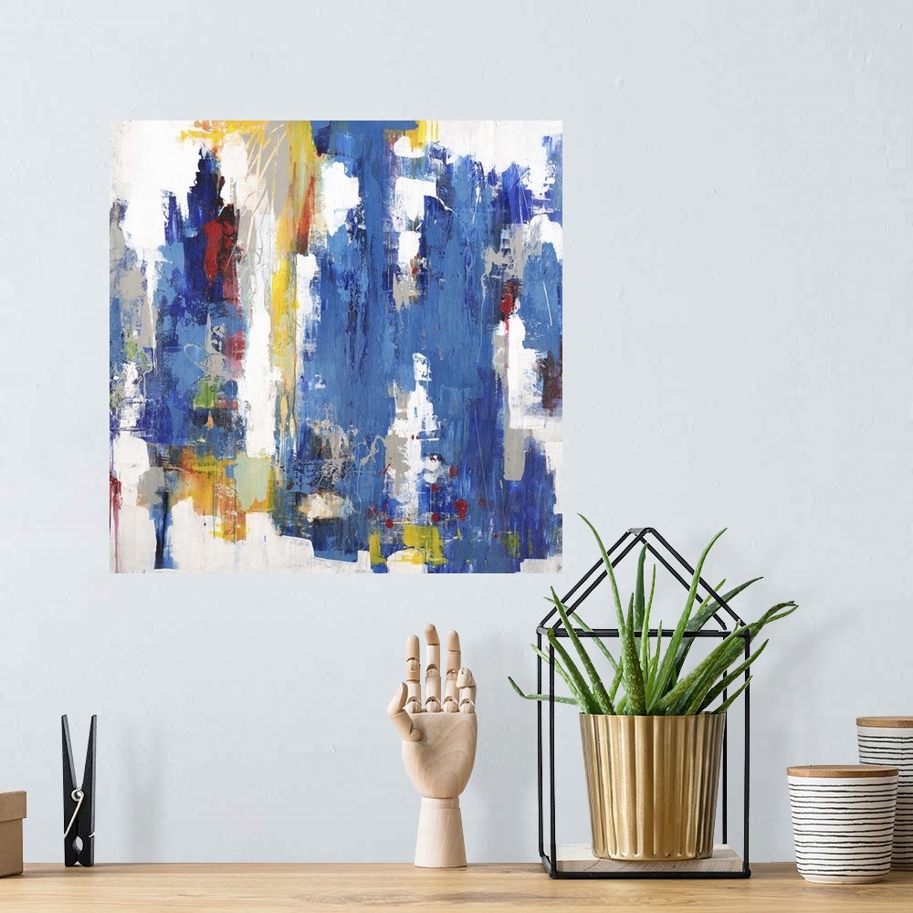 A bohemian room featuring Contemporary abstract painting using mostly blue in vertical swipes with pops of yellow against a...