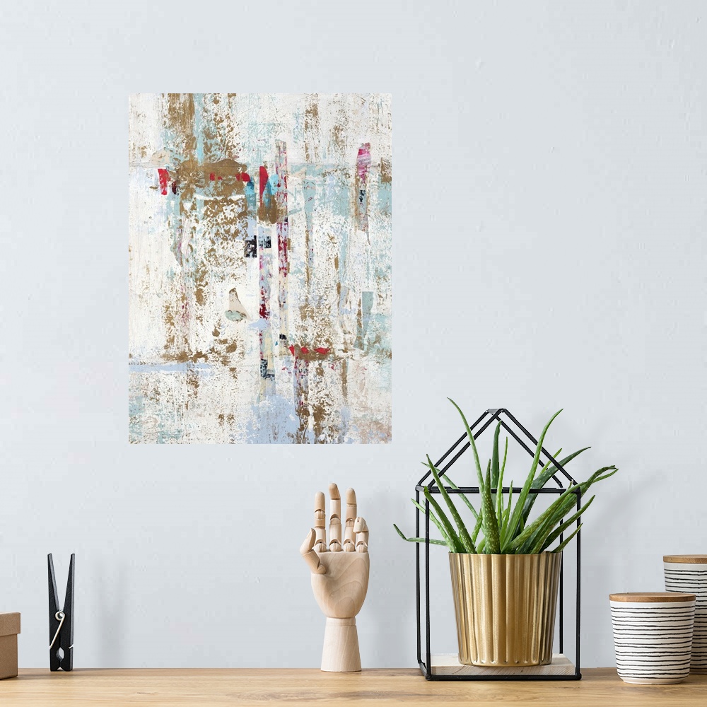A bohemian room featuring Abstract painting with a white background and gold, light blue, and red hues on top.