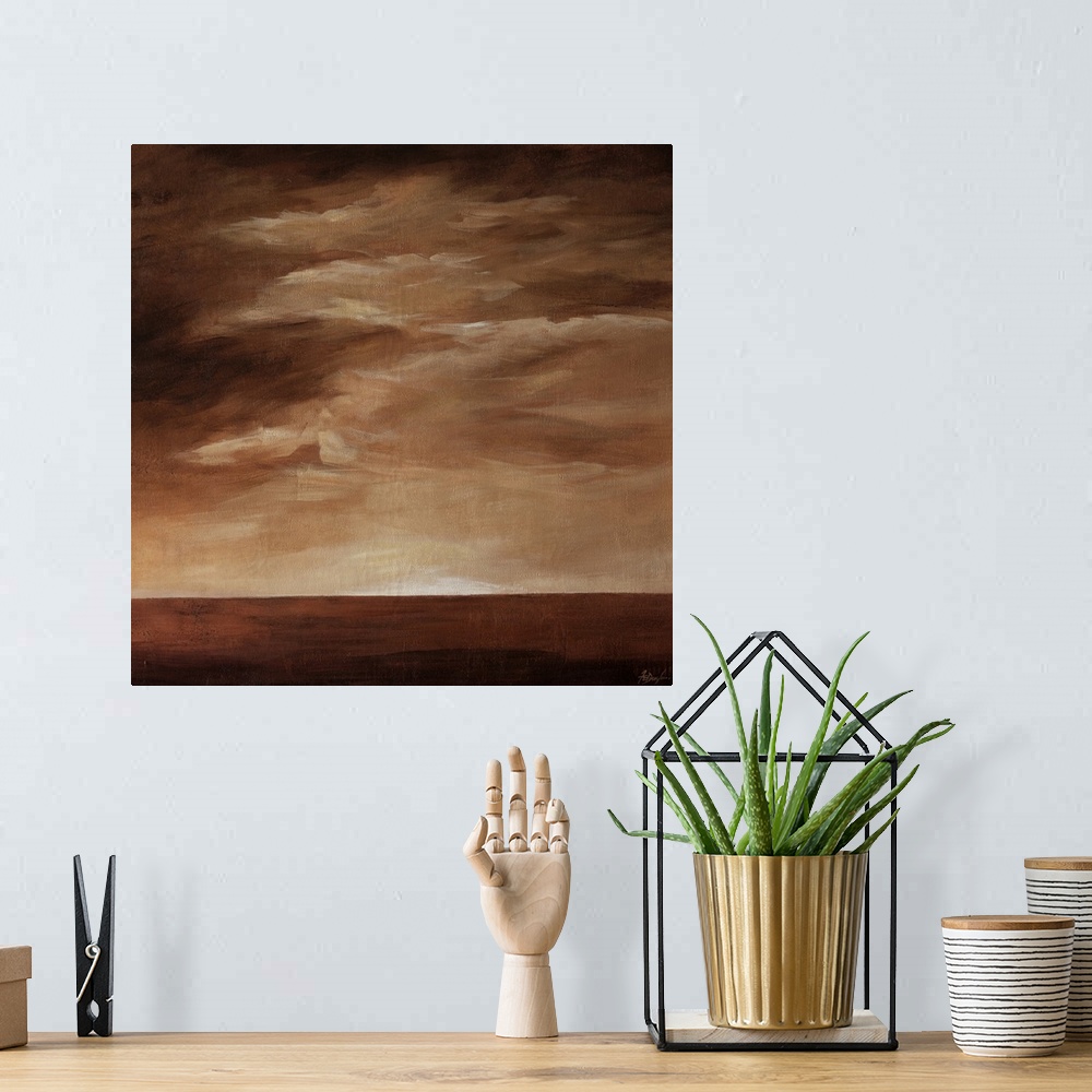 A bohemian room featuring Contemporary landscape painting in brown tones with a cloudy sky.