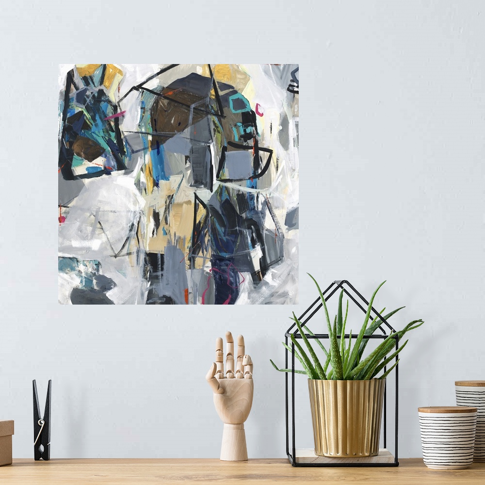 A bohemian room featuring Square abstract art with colorfully compiled, loose, geometric shapes surrounded by shades of gray.