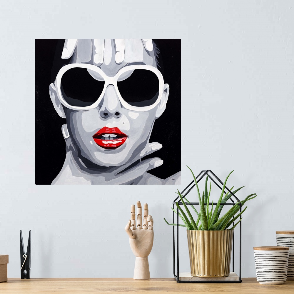 A bohemian room featuring Contemporary pop artwork of a woman's face with large sunglasses, framed by her hands.