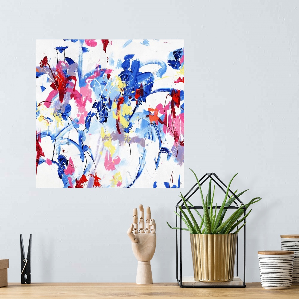 A bohemian room featuring A contemporary abstract painting of various vibrant colors dancing around a white space.