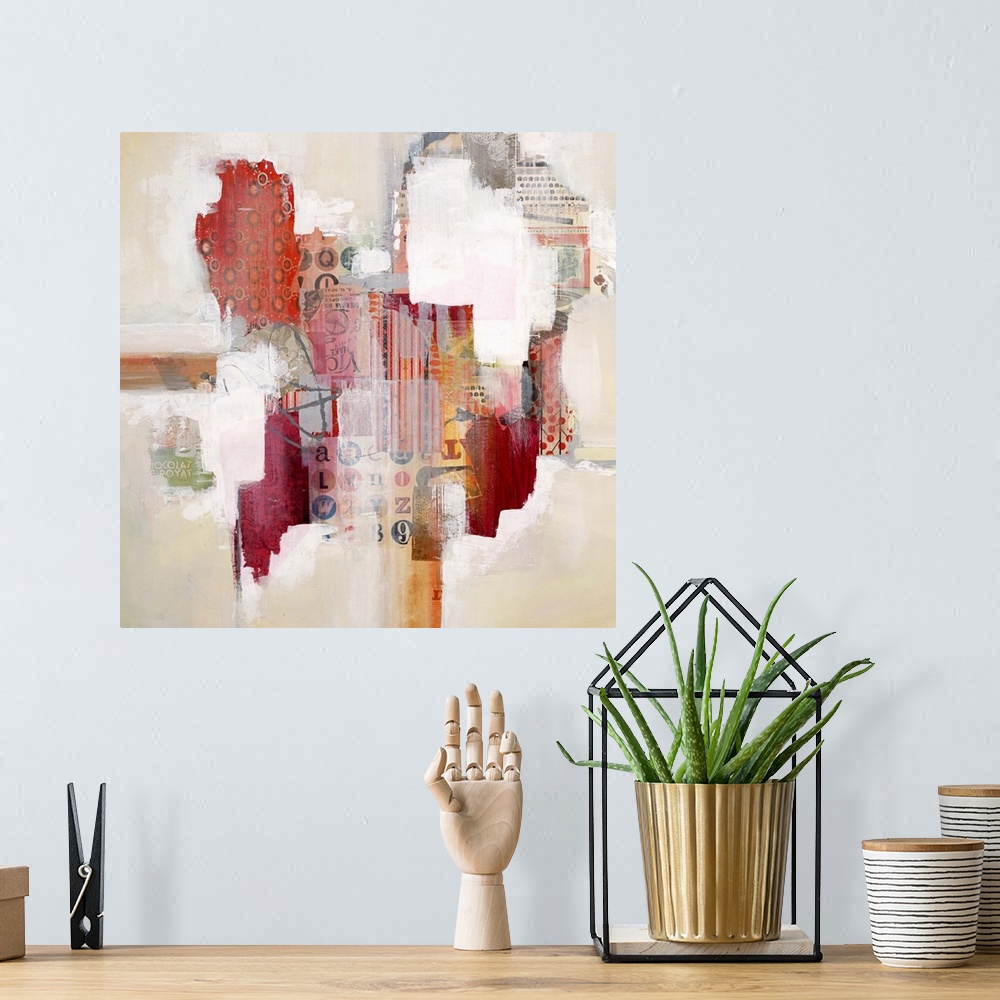 A bohemian room featuring Colorful abstract artwork with bright white spaces among red mixed media blocks.