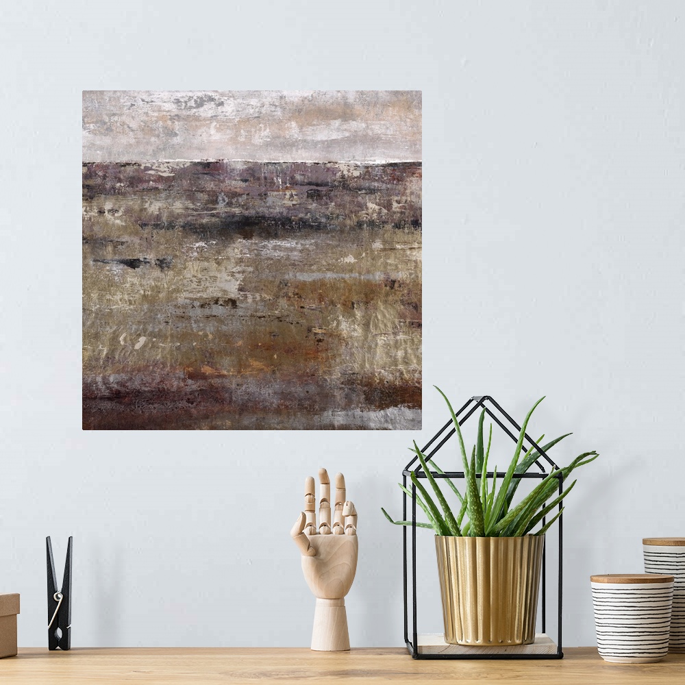 A bohemian room featuring Contemporary artwork of a dark landscape in brown under a light grey sky.