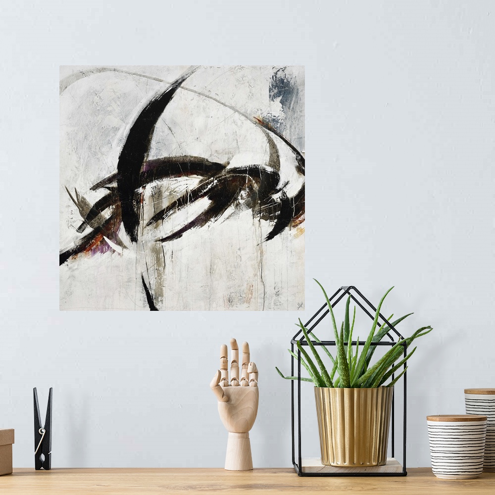 A bohemian room featuring Abstract painting using harsh black paint strokes against a neutral background.