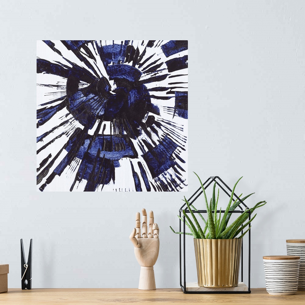 A bohemian room featuring Square abstract painting with a blue circular splatter design on a gray background.