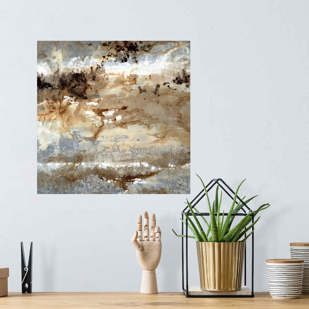A bohemian room featuring Square abstract art with silver, brown, black, and white hues.