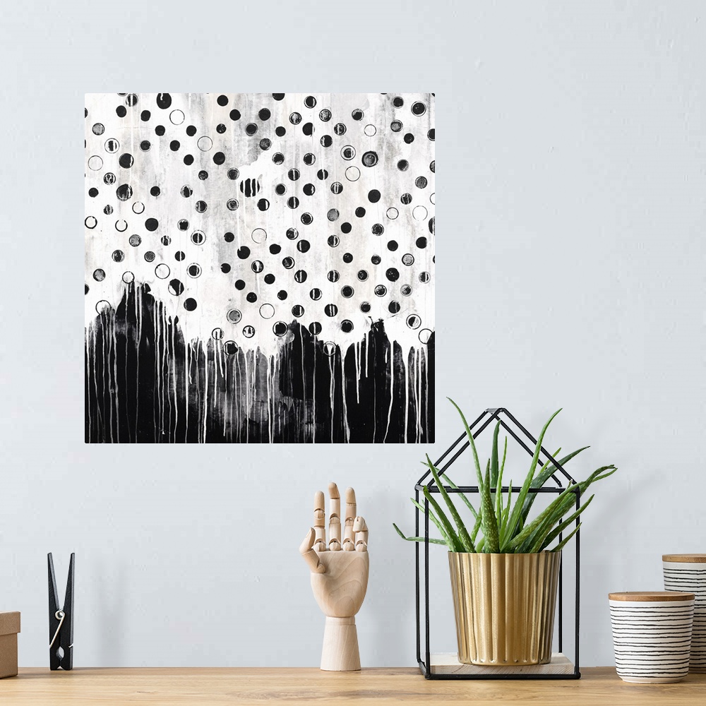 A bohemian room featuring Contemporary abstract painting in black and white, with a dripping paint effect.