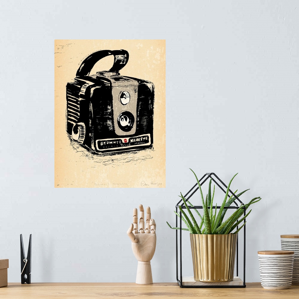 A bohemian room featuring 1940's vintage style wall art of a kodak brownie camera illustrated in black ink wash on distress...
