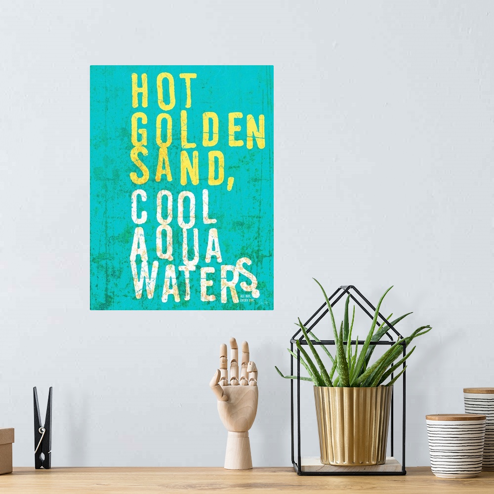 A bohemian room featuring Beach house looking wall art with distressed wording reading Hot golden sand, cool aqua waters on...