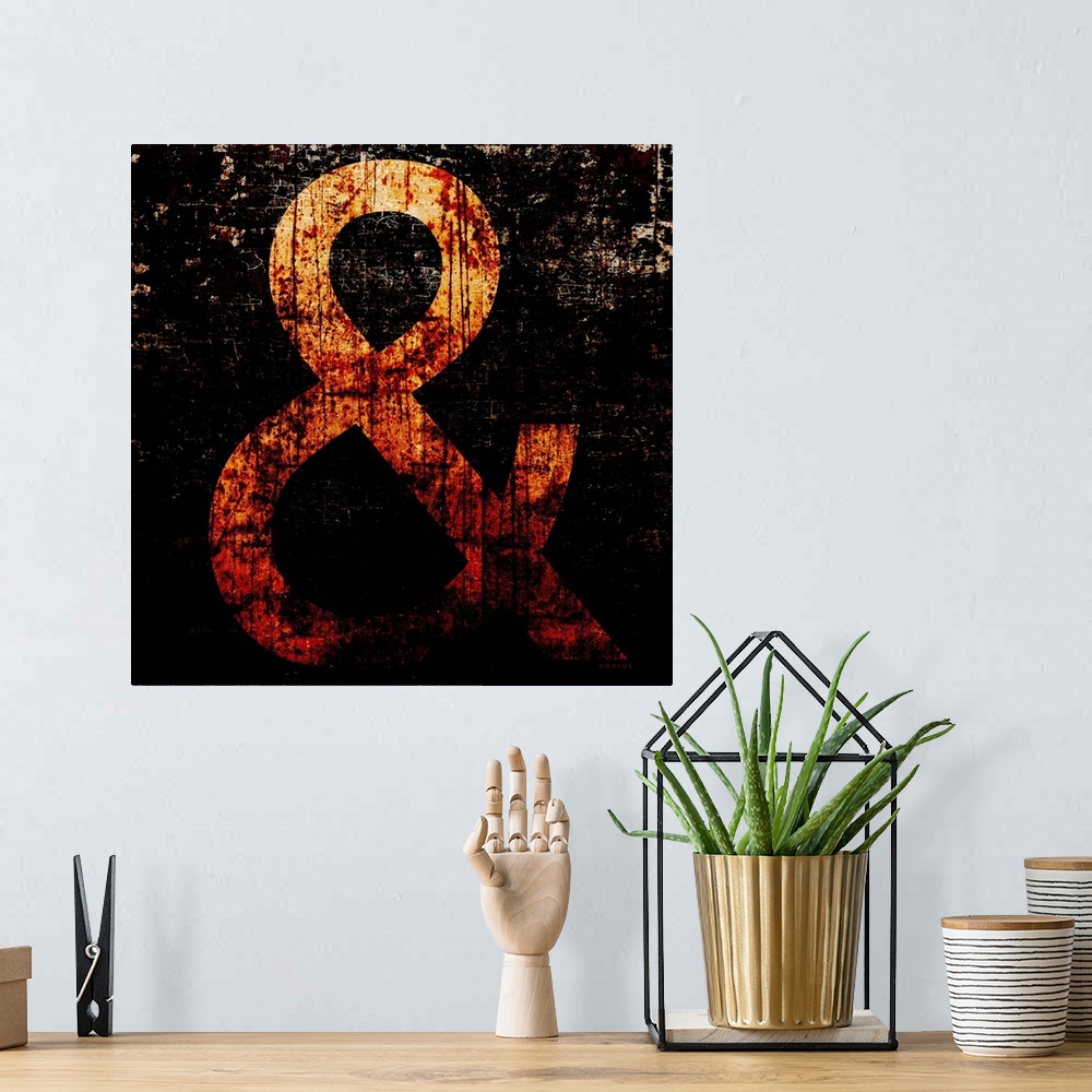 A bohemian room featuring Rusty typography wall art of a large yellow ampersand character on black background.