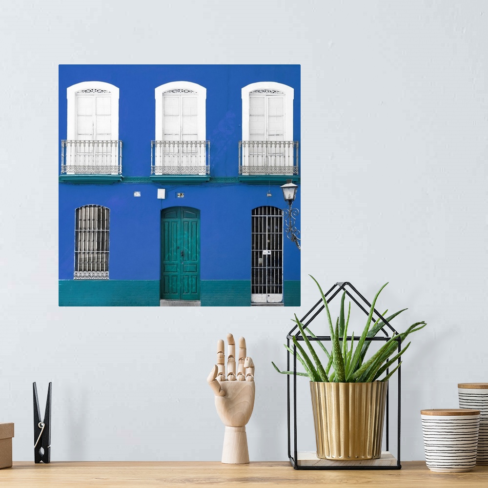 A bohemian room featuring It's a beautiful blue facade of an old building in Seville, Spain.