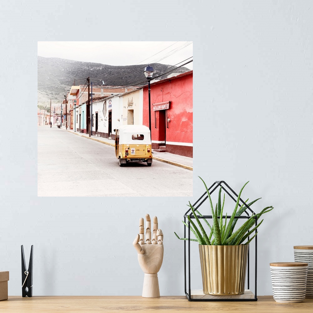 A bohemian room featuring Square ashed out photograph of a Mexican street scene with a yellow Tuk Tuk on the road. From the...