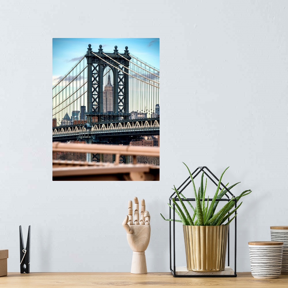 A bohemian room featuring A photograph of the Manhattan bridge, with the Empire state building in the background.
