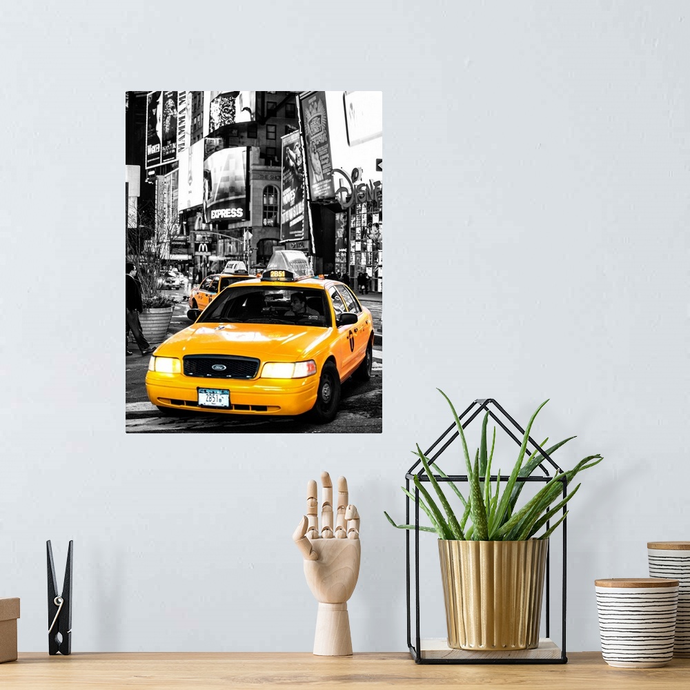 A bohemian room featuring A black and white photograph of New York city with a bright yellow taxi in focus.