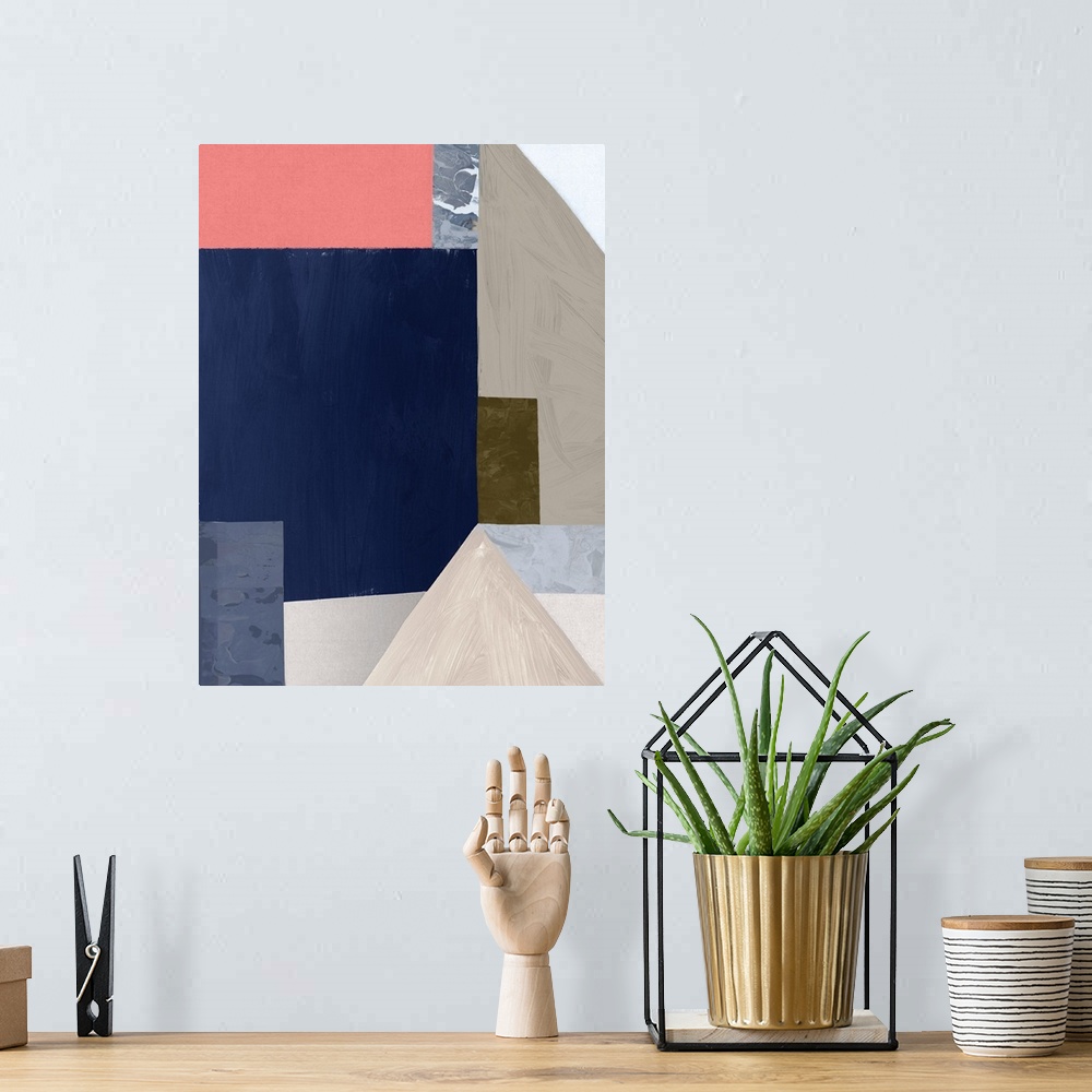 A bohemian room featuring Color block abstract artwork with shades of navy blue and coral pink.