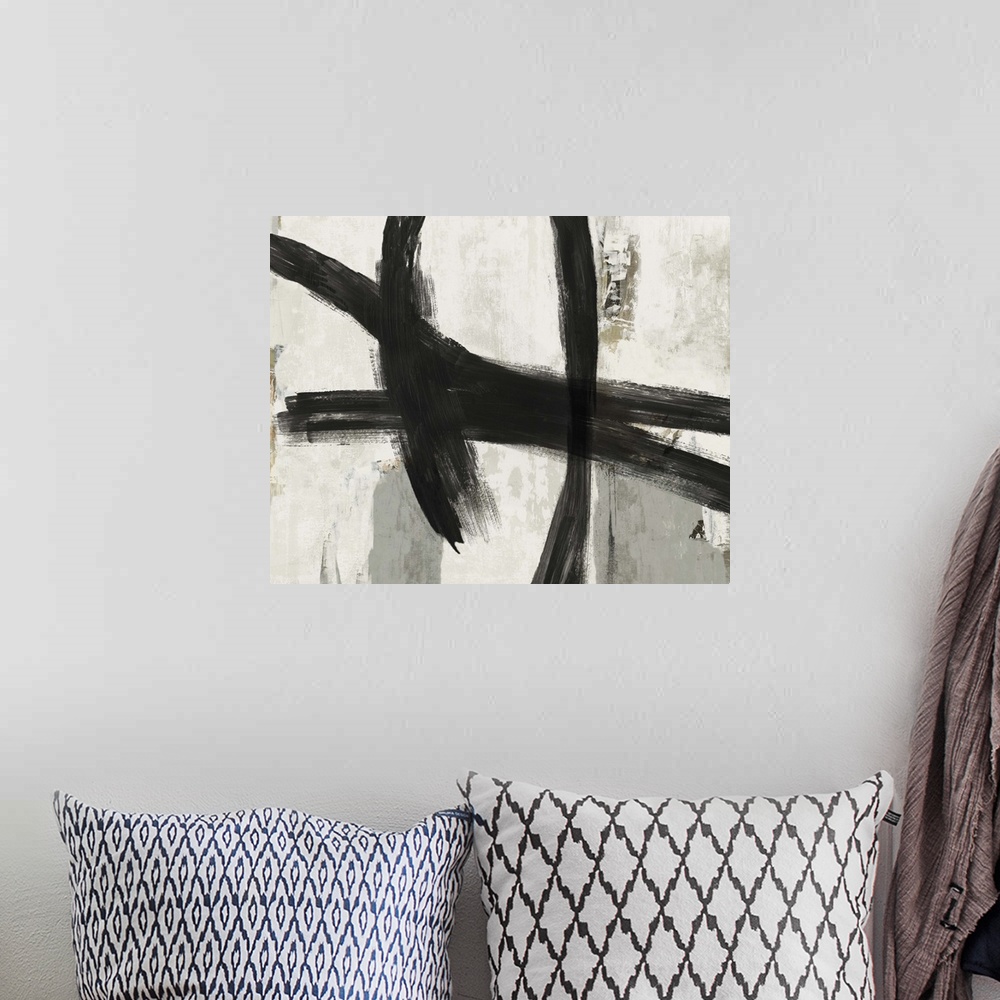 A bohemian room featuring Abstract artwork of dark black strokes over cream and grey.