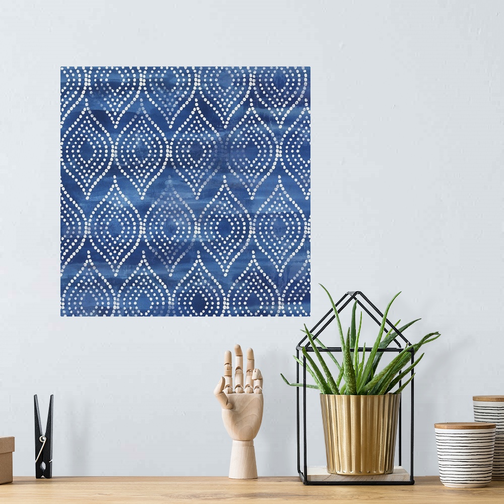 A bohemian room featuring Watercolor artwork of a navy blue Shibori style pattern.