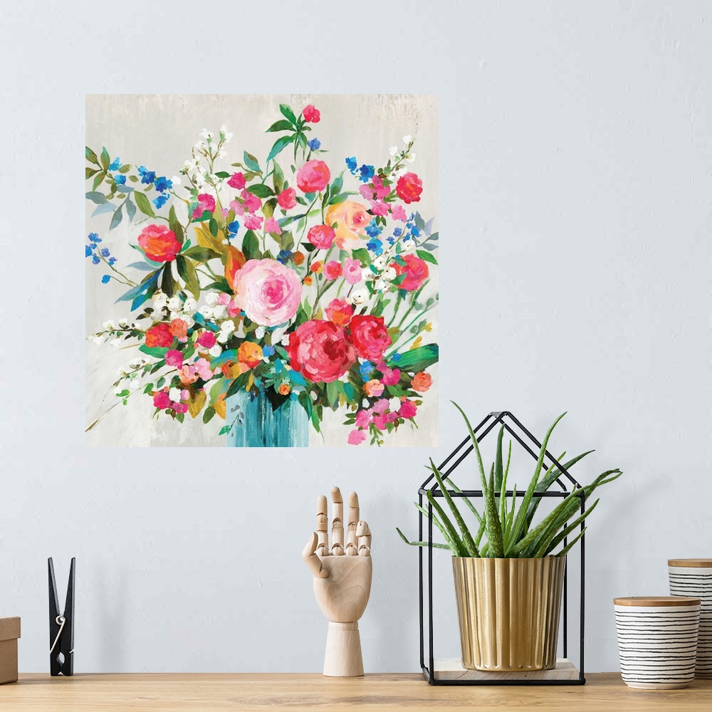 A bohemian room featuring A square painting of bright flowers in a vase against a gray backdrop.