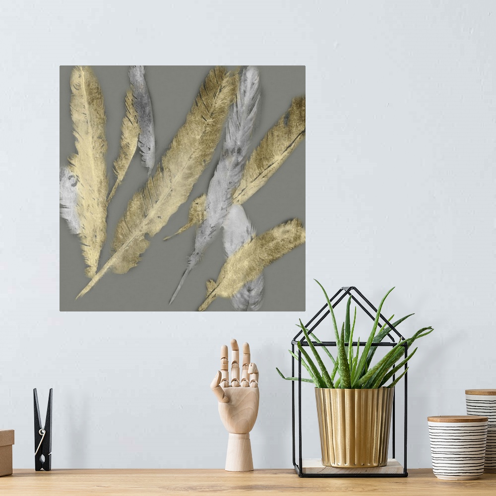 A bohemian room featuring Contemporary home decor artwork of gold and silver feathers fluttering against a gray background.