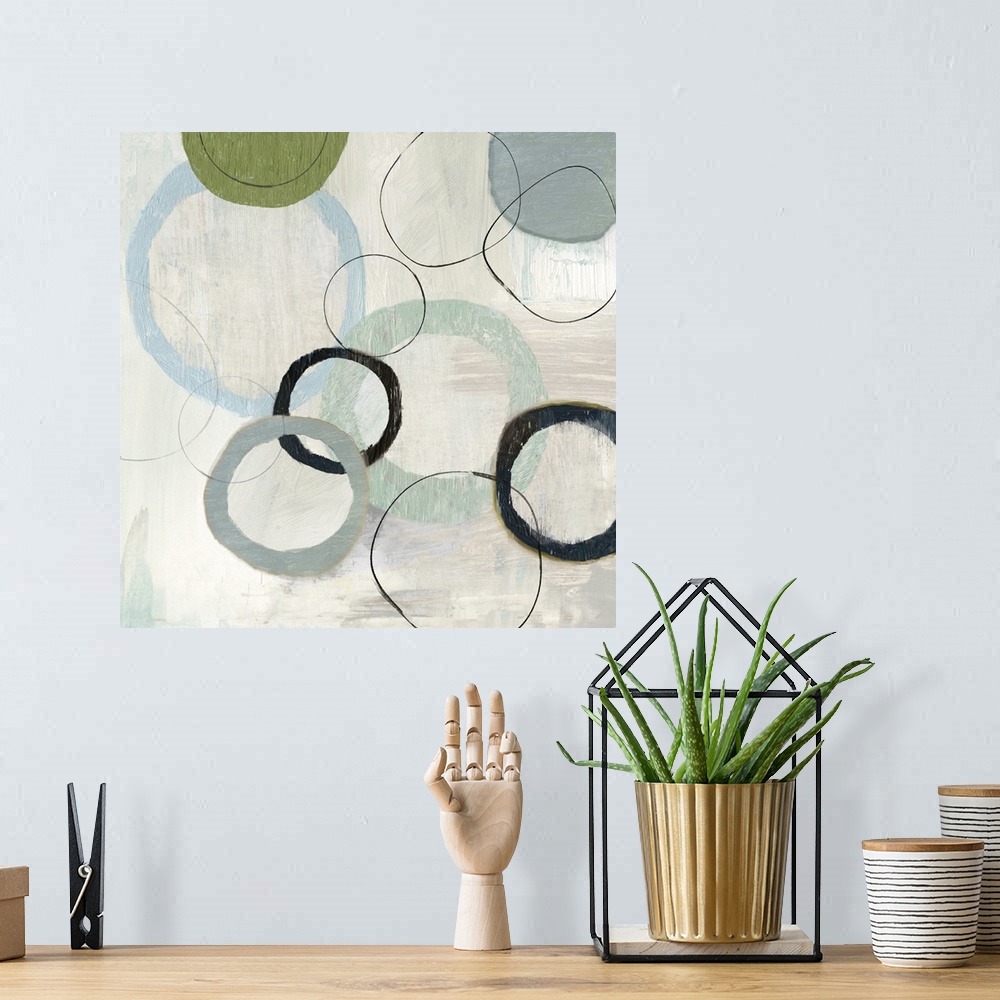 A bohemian room featuring An abstract painting of circles in varies sizes and colors