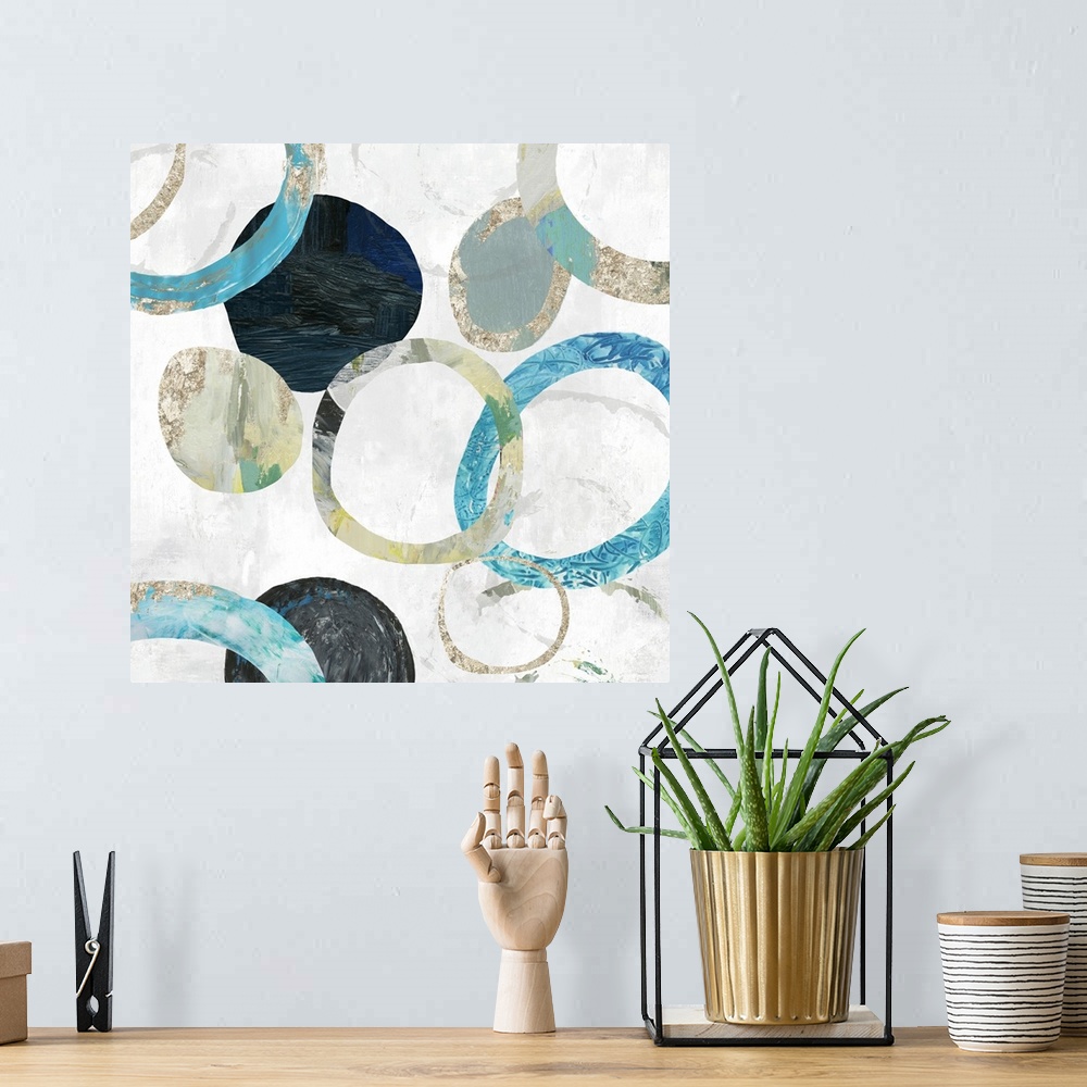 A bohemian room featuring Square contemporary painting of multi- color circles in tones of blue, green and gold.