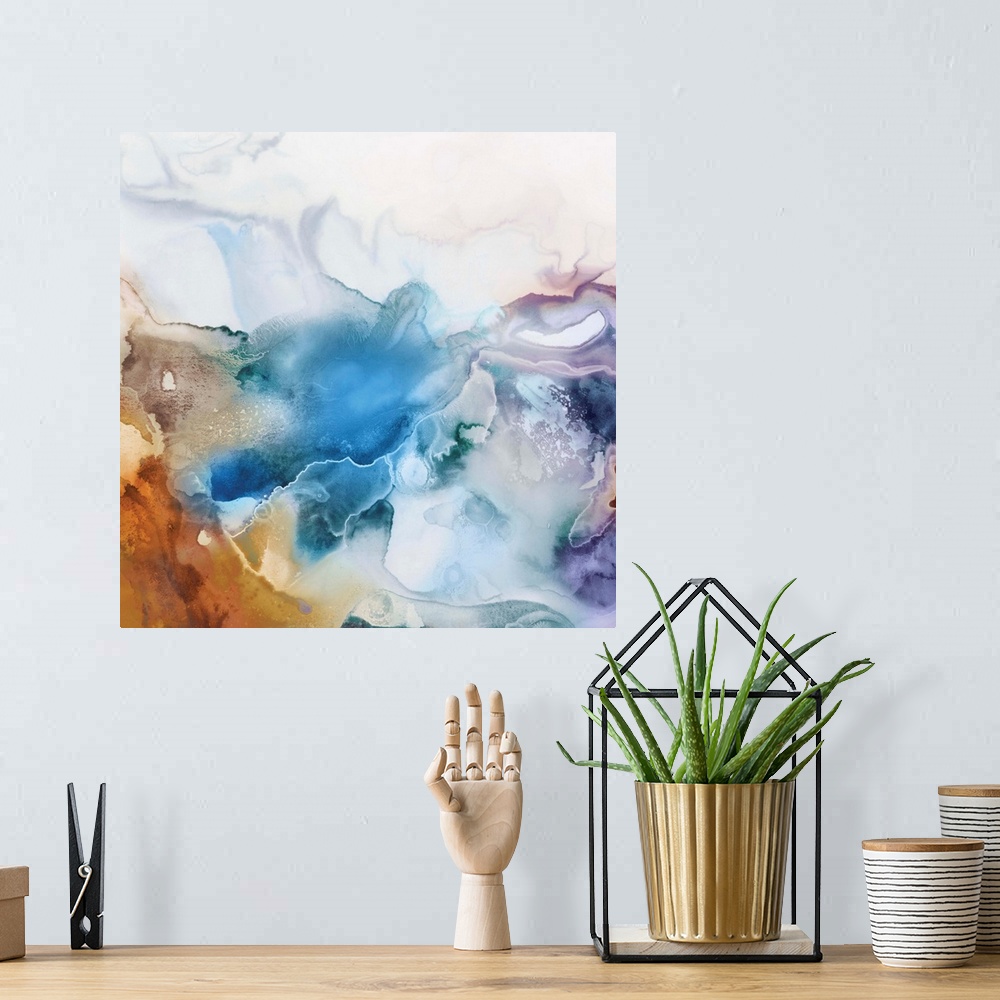 A bohemian room featuring Abstract watercolor artwork of softly blending shades of blue, lavender, and orange.