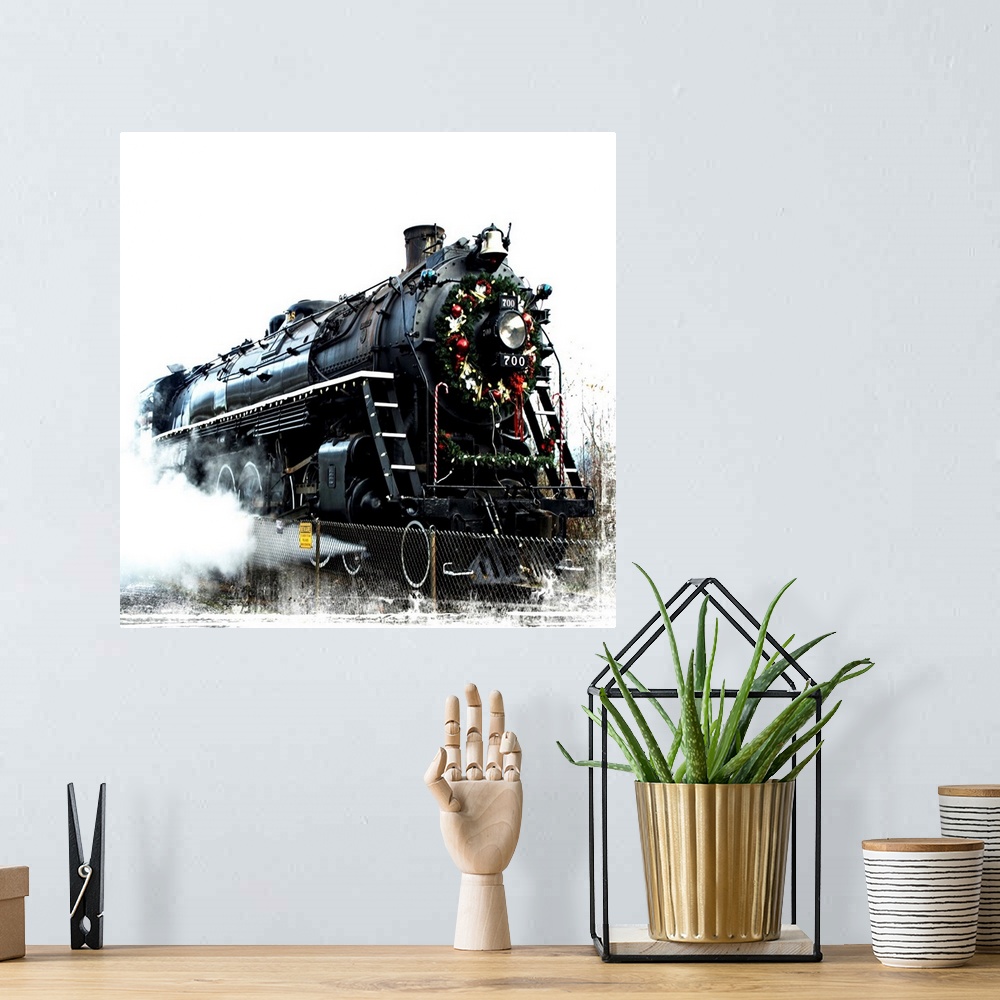 A bohemian room featuring A black locomotive with a festive wreath on its nose.