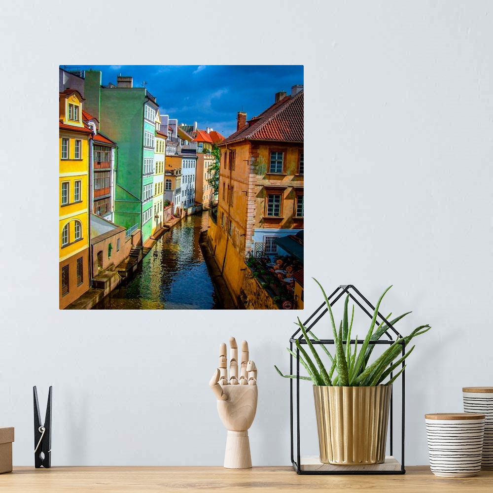 A bohemian room featuring Colorful buildings along the canal in Prague.