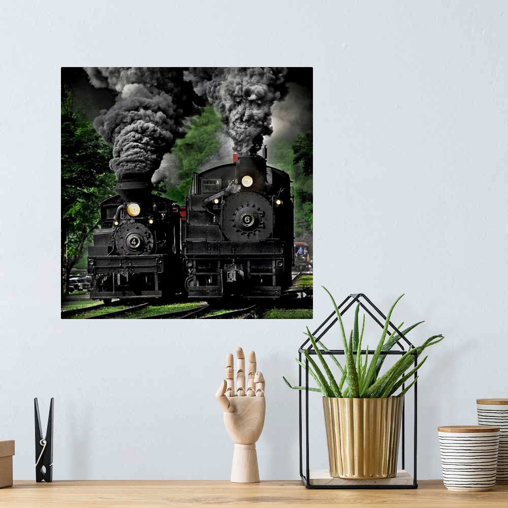 A bohemian room featuring Two black locomotives approaching on the railroad tracks.