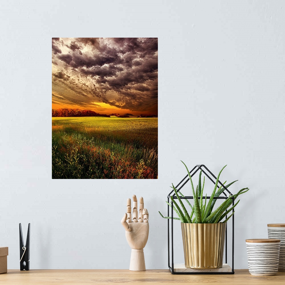 A bohemian room featuring Dramatic cloudscape at sunset over a field of farmland.