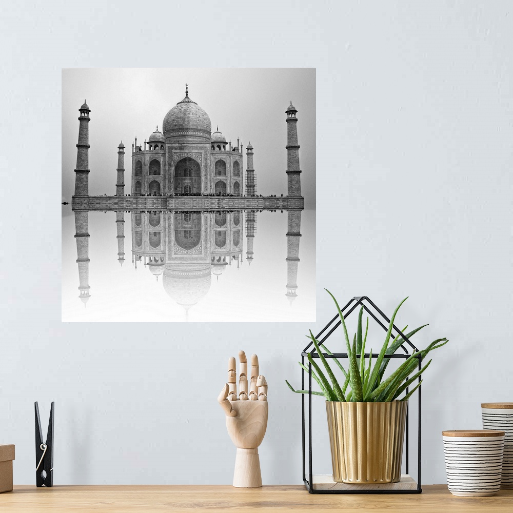A bohemian room featuring Black and white photo of the Taj Mahal reflected in the water below.