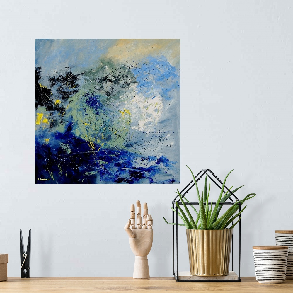 A bohemian room featuring A vertical abstract painting in textured shades of black, blue, white and yellow with splatters o...