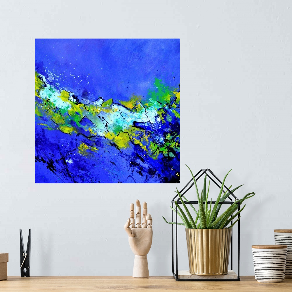 A bohemian room featuring A square abstract painting in dark shades of blue, green and yellow with splatters of paint overl...