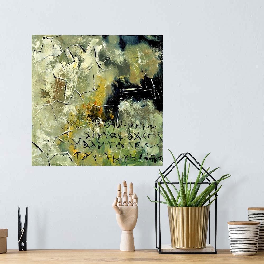 A bohemian room featuring A square abstract painting in textured shades of black, green and yellow with splatters of paint ...