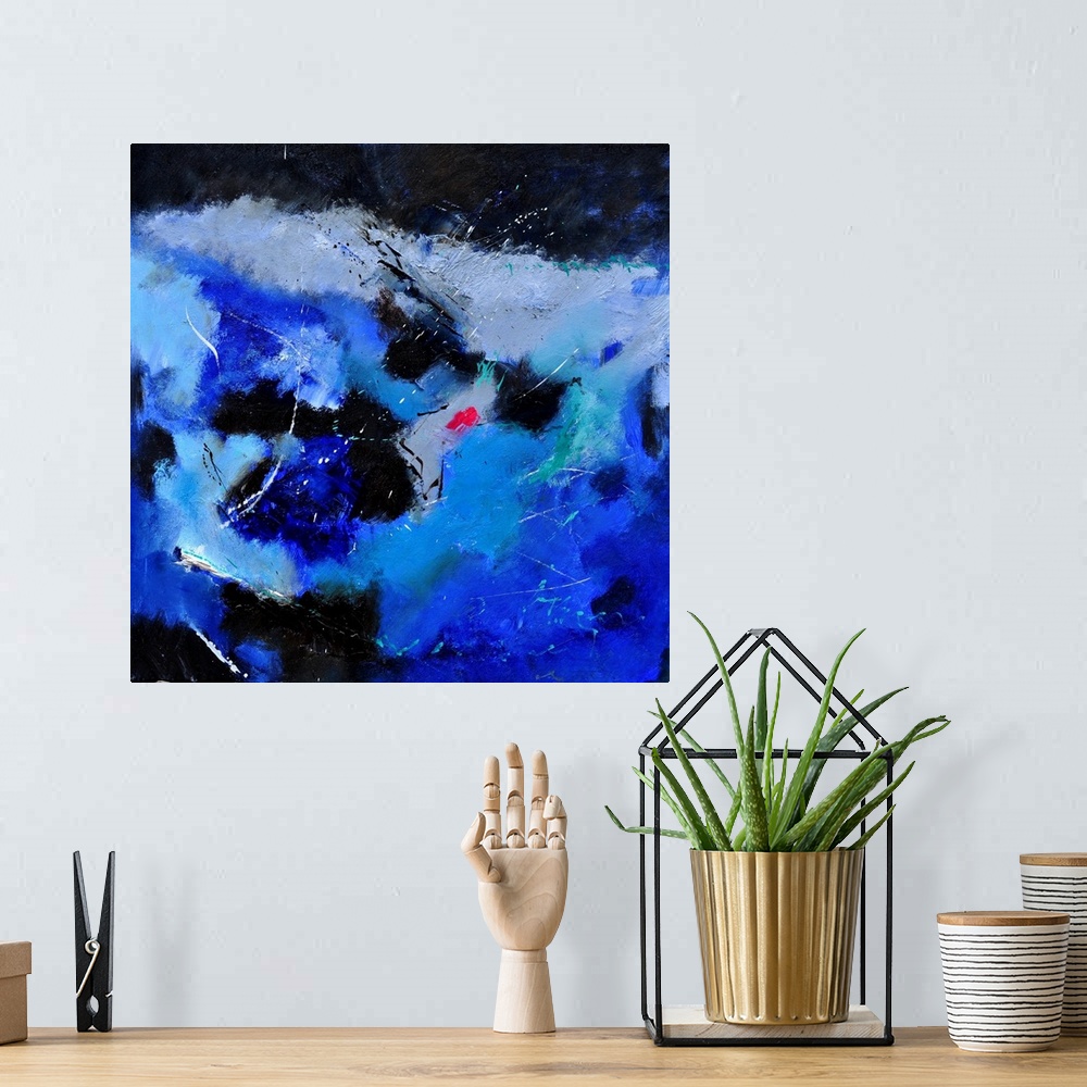 A bohemian room featuring A square abstract painting of colors of black, white and blue in bold brush strokes and splattere...