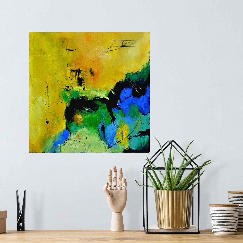 A bohemian room featuring A square abstract painting in shades of green, blue, white and yellow with splatters of paint ove...