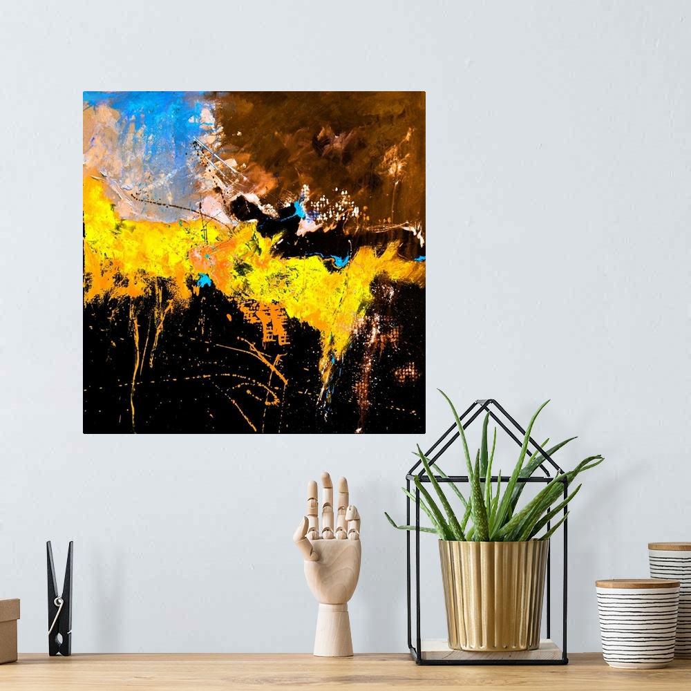 A bohemian room featuring A square abstract painting in textured shades of orange, blue, brown and yellow with splatters of...