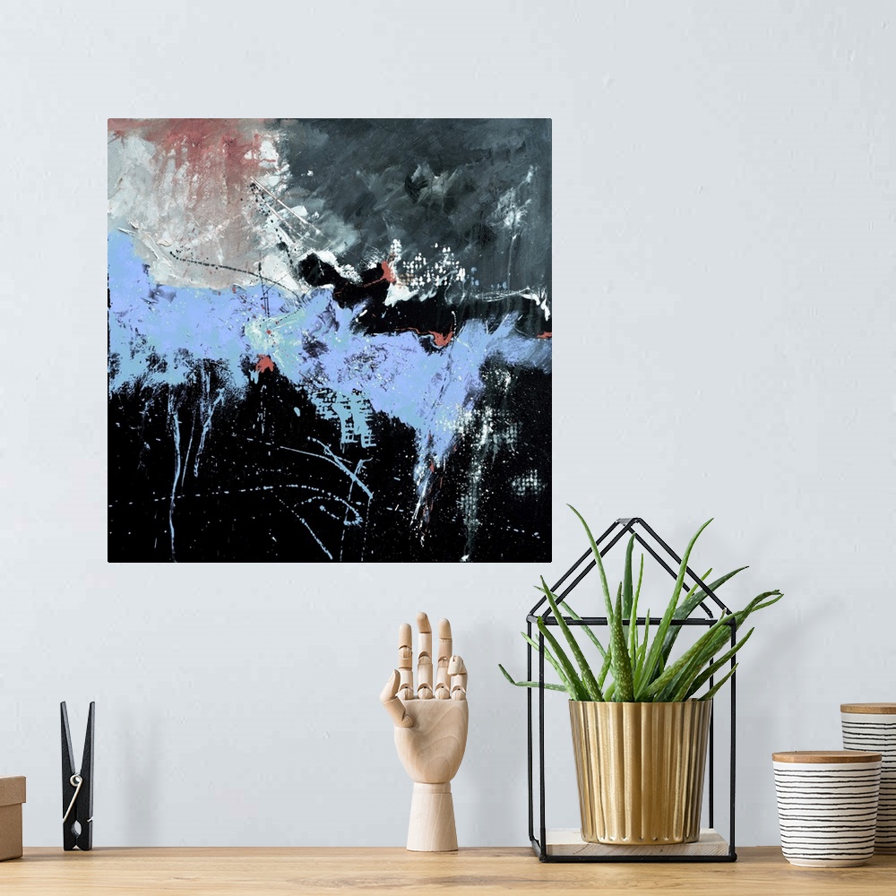 A bohemian room featuring A square abstract painting in textured shades of black, blue and gray with splatters of paint ove...
