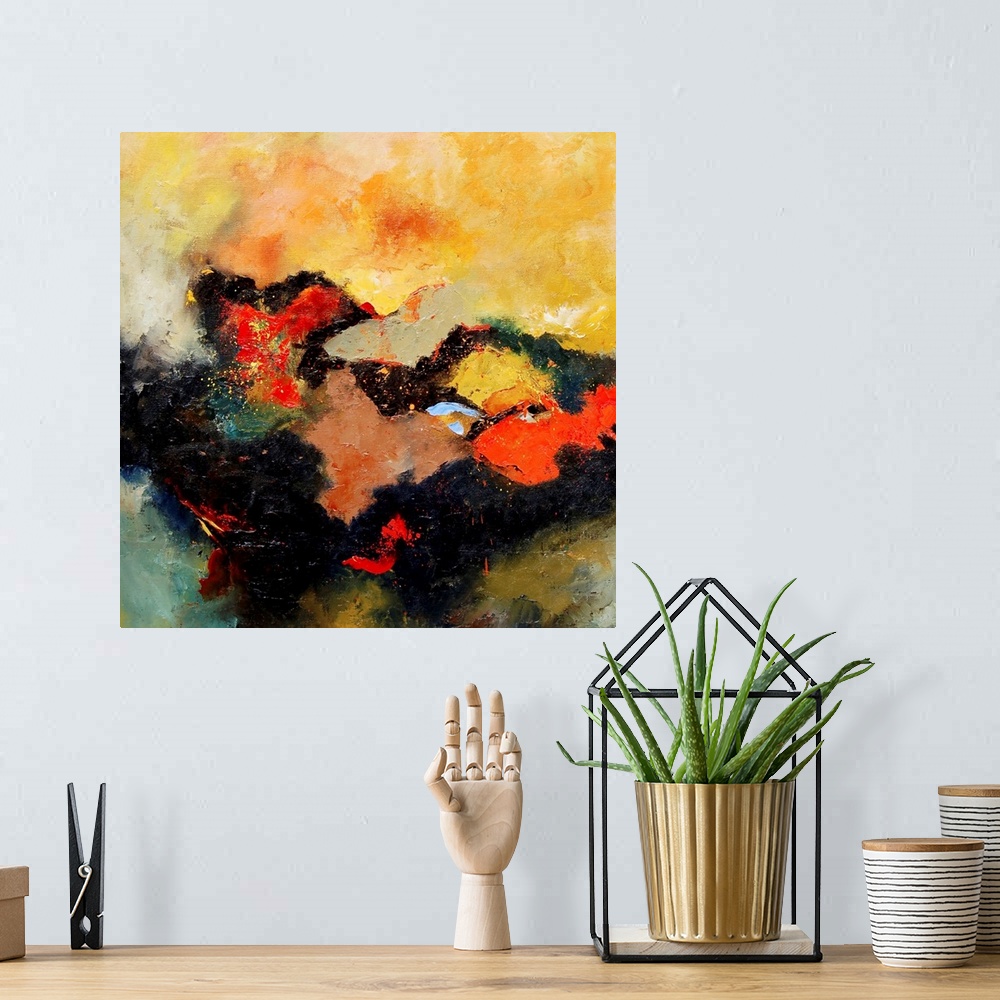 A bohemian room featuring A square abstract landscape with vivid colors of yellow and orange.