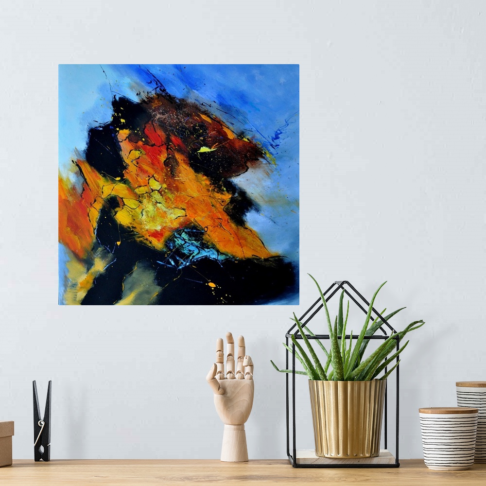 A bohemian room featuring Abstract painting in shades of orange, yellow, blue and red mixed in with black contrasting designs.