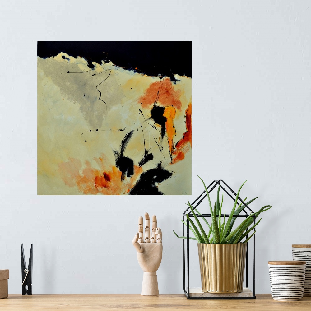 A bohemian room featuring A square abstract painting with muted colors of orange and yellow.