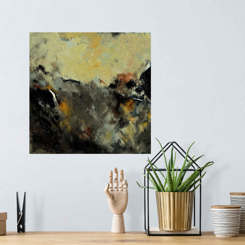 A bohemian room featuring A square abstract painting in dark shades of black, brown, white and yellow with splatters of pai...