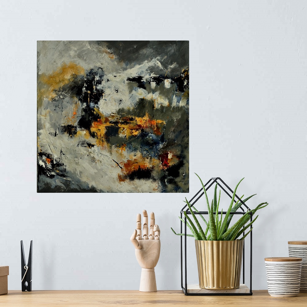 A bohemian room featuring A square abstract painting in dark shades of black, gray and yellow with splatters of paint overl...