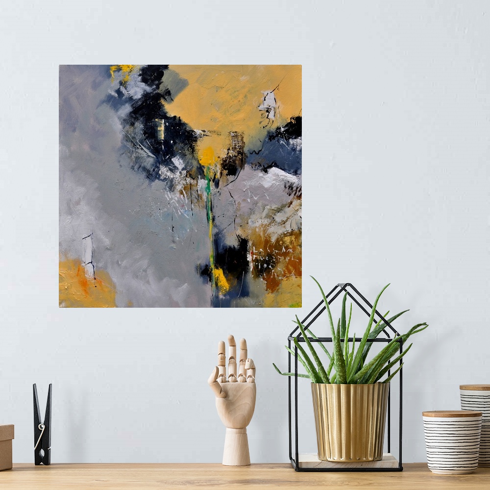 A bohemian room featuring A square abstract painting in dark shades of black, gray, white and yellow with splatters of pain...