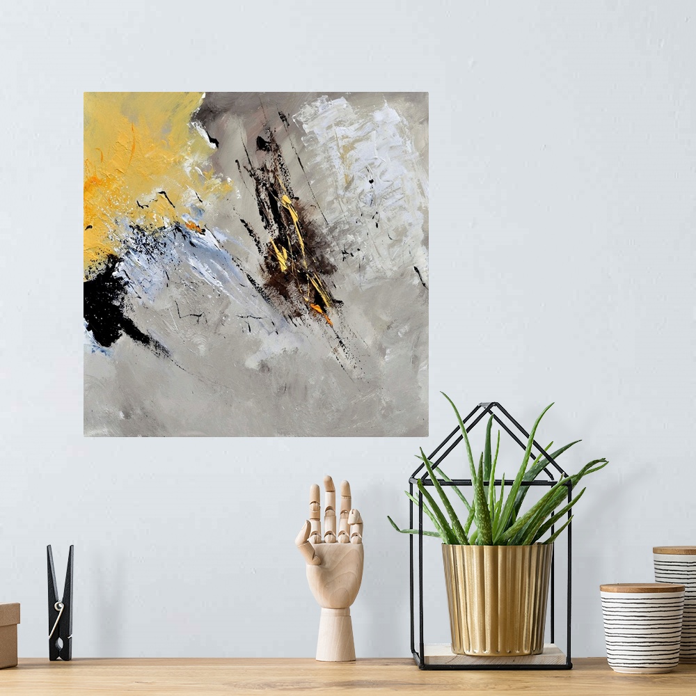 A bohemian room featuring Abstract painting in shades of black, gray, white and yellow with splatters of paint overlapping.